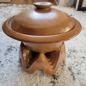 Frankoma Pottery bean pot with a lid and a warmer stand.